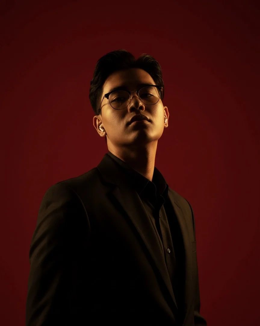 Portrait of Pyi Hein San wearing a black suit.